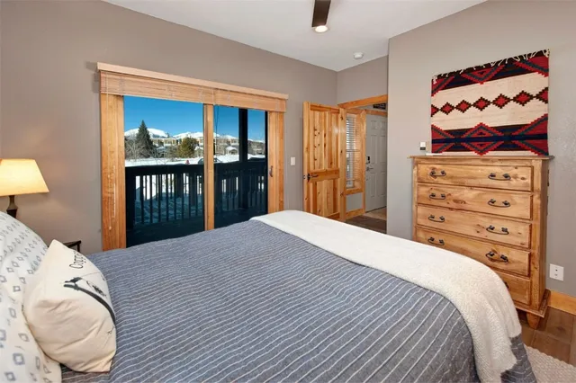 a bedroom with a bed and painting on the wall