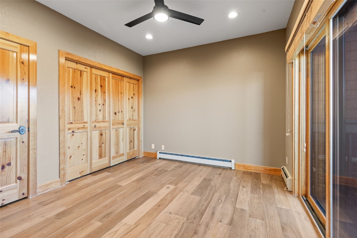 164 Buck Ridge Road, Unit 164 Summit Cove, CO 80435 - Photo 16 of 28 an empty room with wooden floor and windows