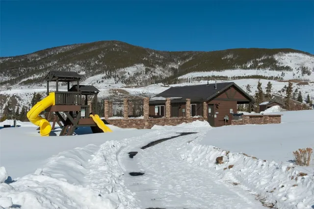 a view of a house with a snow in the mountains