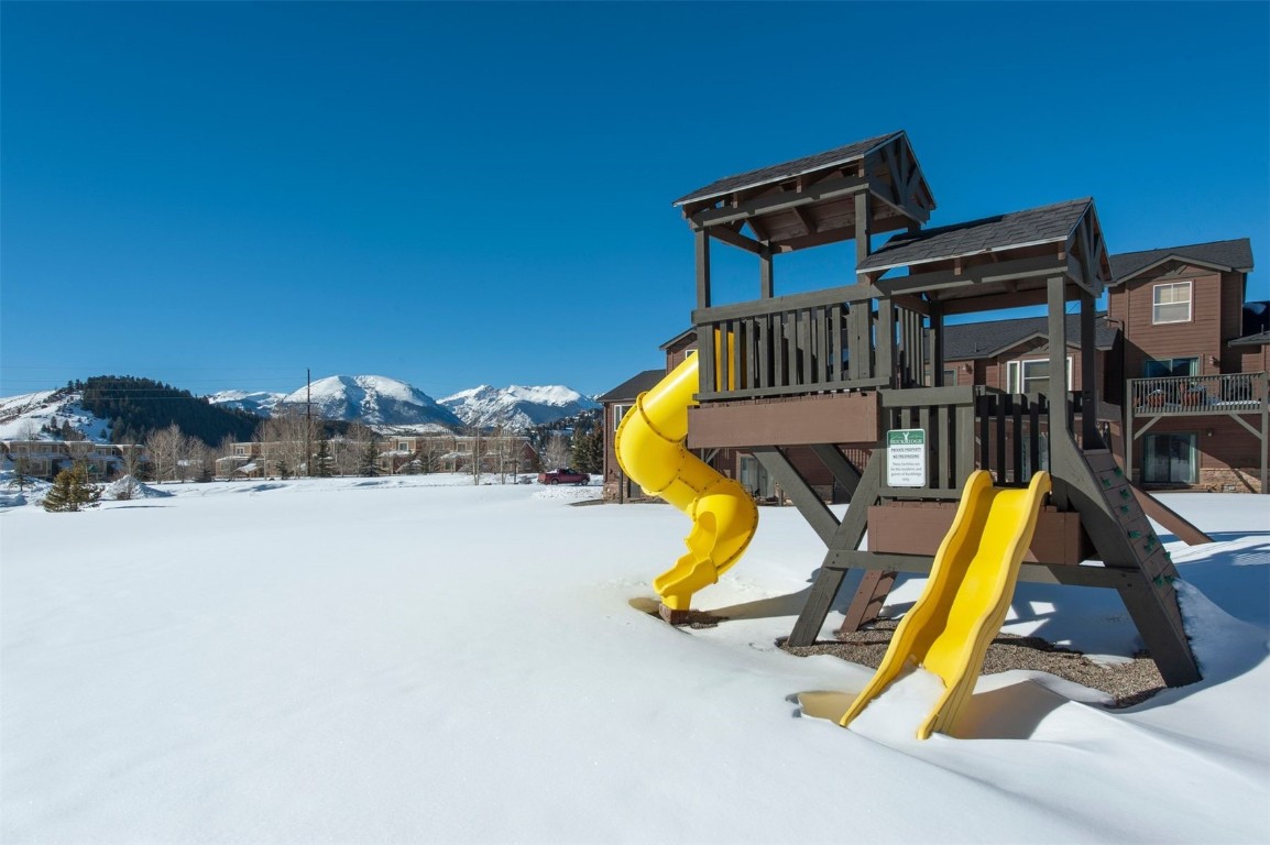 164 Buck Ridge Road, Unit 164 Summit Cove, CO 80435 - Photo 27 of 28 a view of a swimming pool with a chairs and potted plants