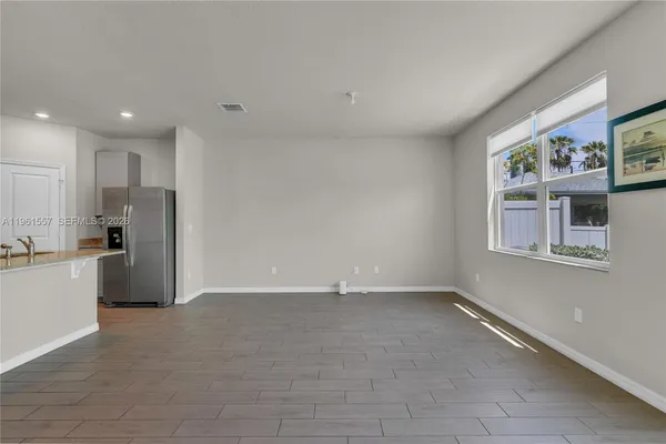a view of an empty room with a kitchen