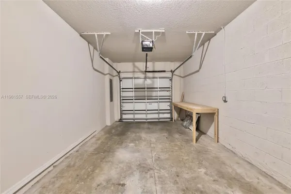 a view of a kitchen with wooden floor and electronic appliances
