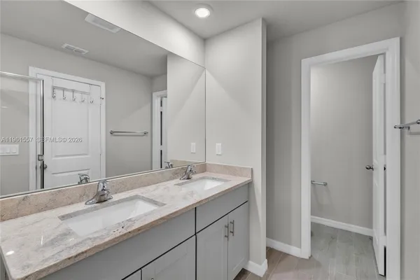 a bathroom with a granite countertop sink mirror and double