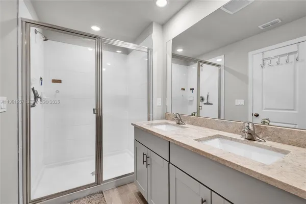 a bathroom with a granite countertop sink mirror and double