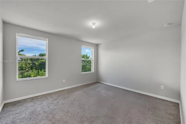 a bedroom with bed and a window