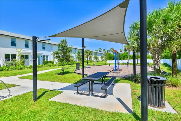 a view of house with backyard outdoor seating area