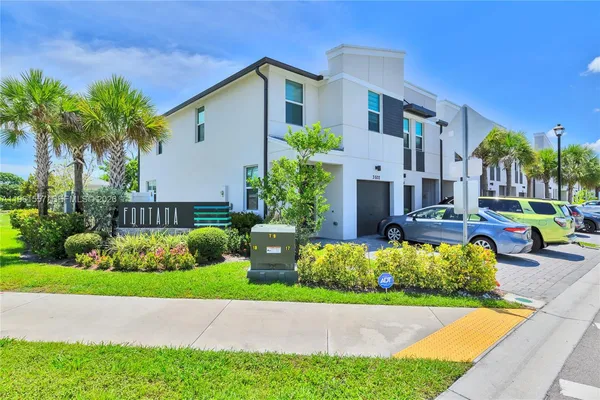 a view of a house with a yard and garden