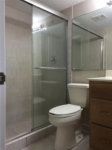 a bathroom with a toilet and a shower