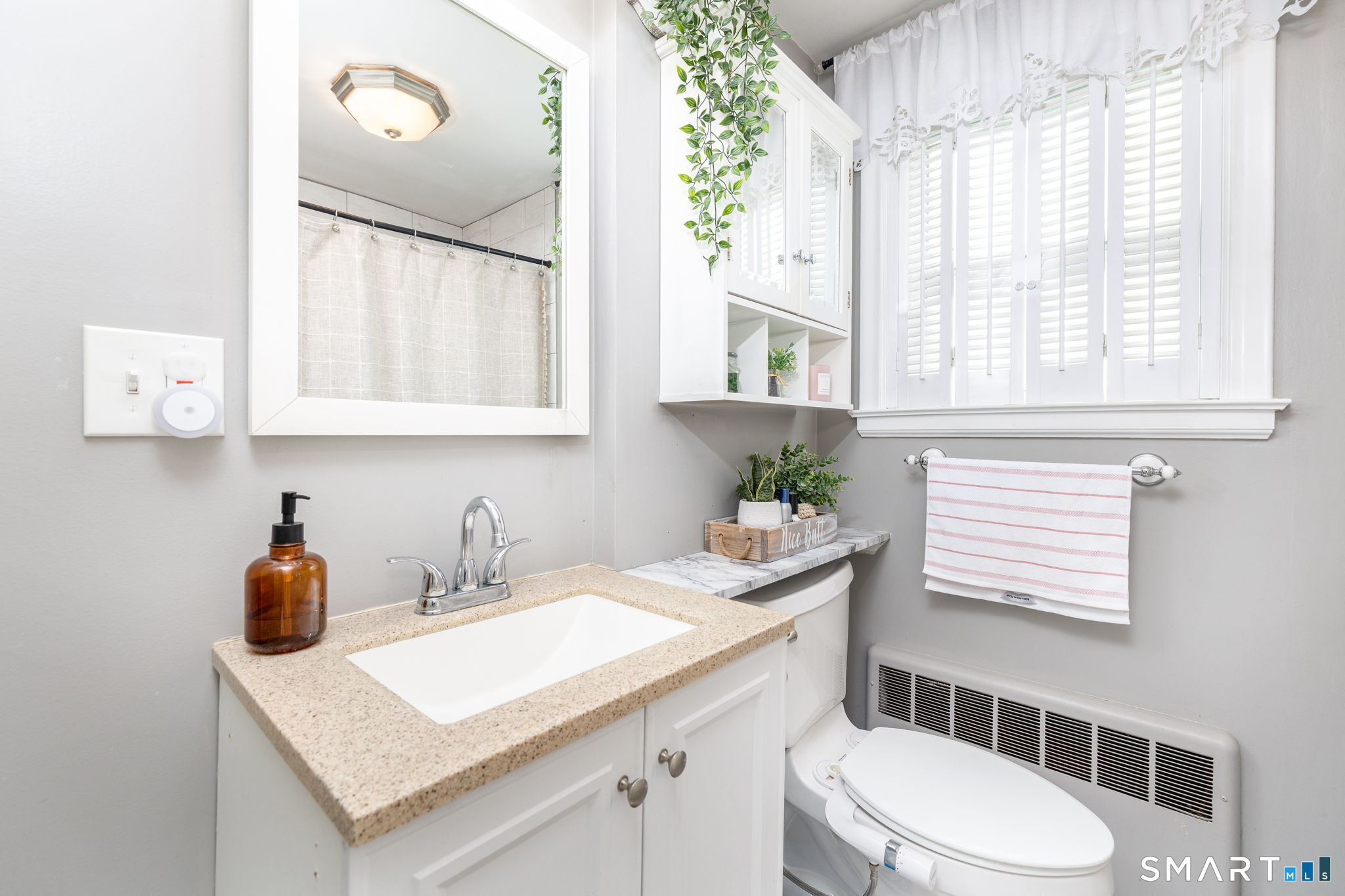 18 Debra Lane Bristol, CT 06010 - Photo 18 of 32 a bathroom with a sink a toilet and a window