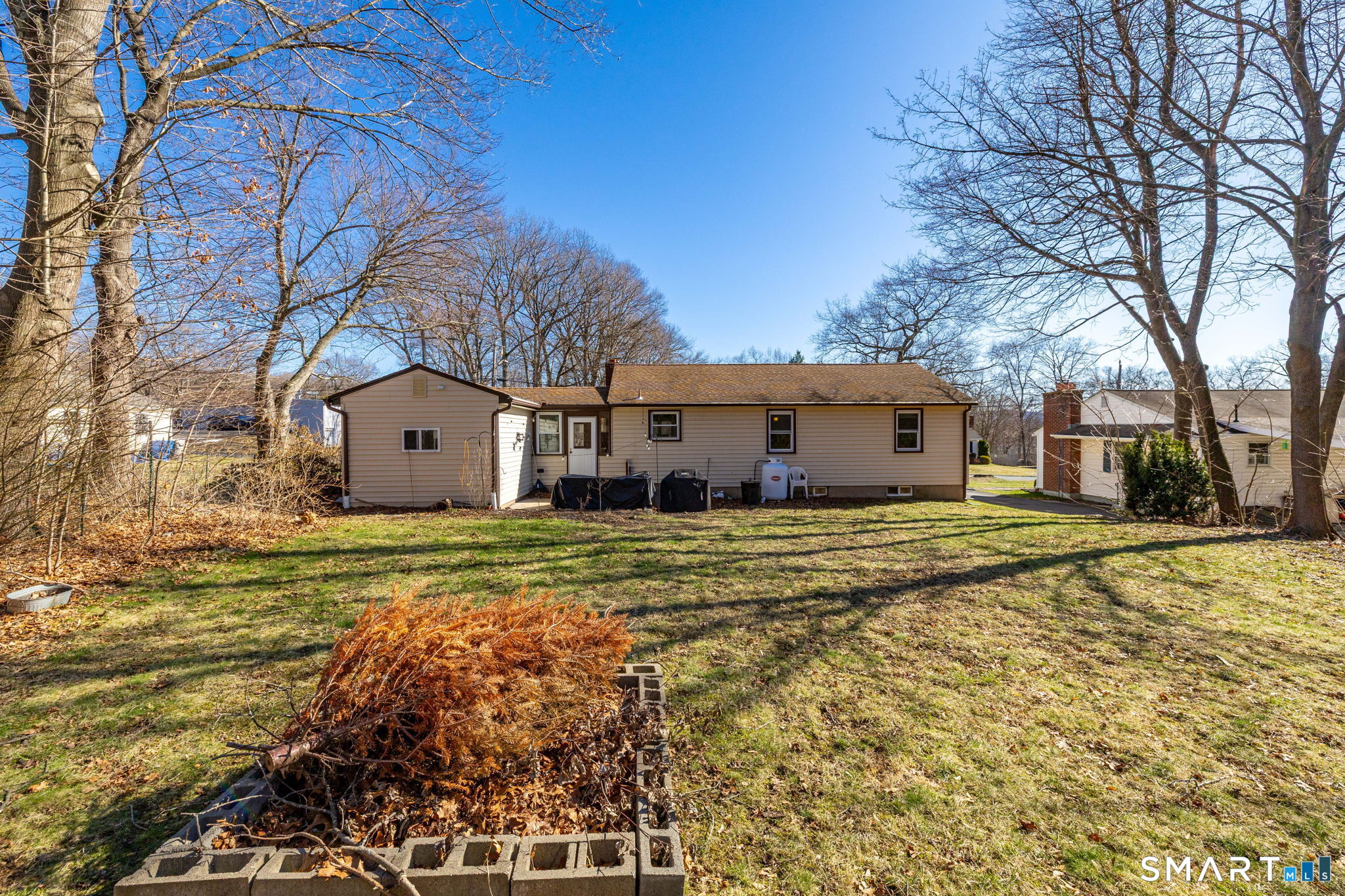 18 Debra Lane Bristol, CT 06010 - Photo 22 of 32 a front view of house with yard and trees