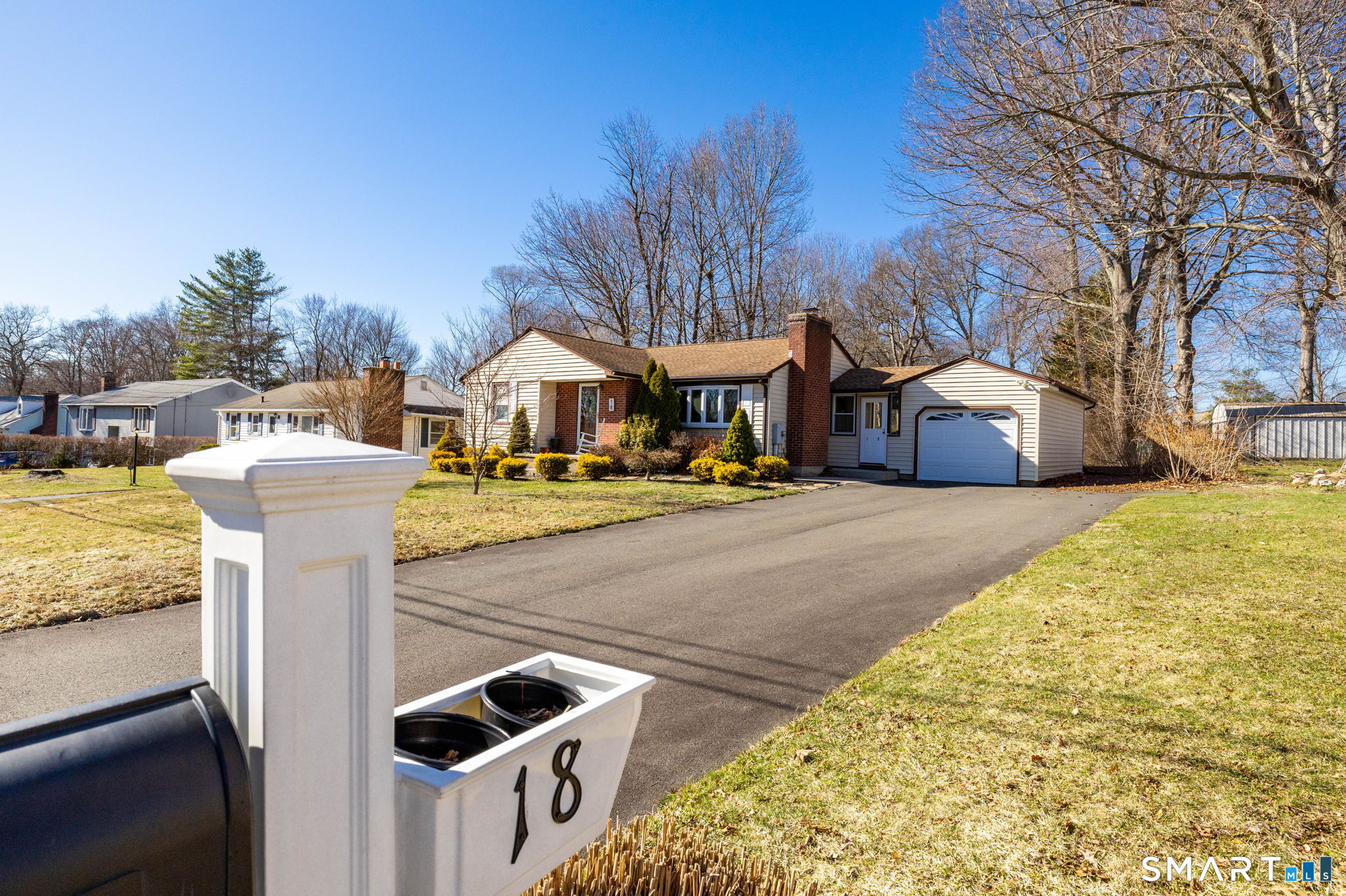 18 Debra Lane Bristol, CT 06010 - Photo 28 of 32 a front view of a building with garden and trees