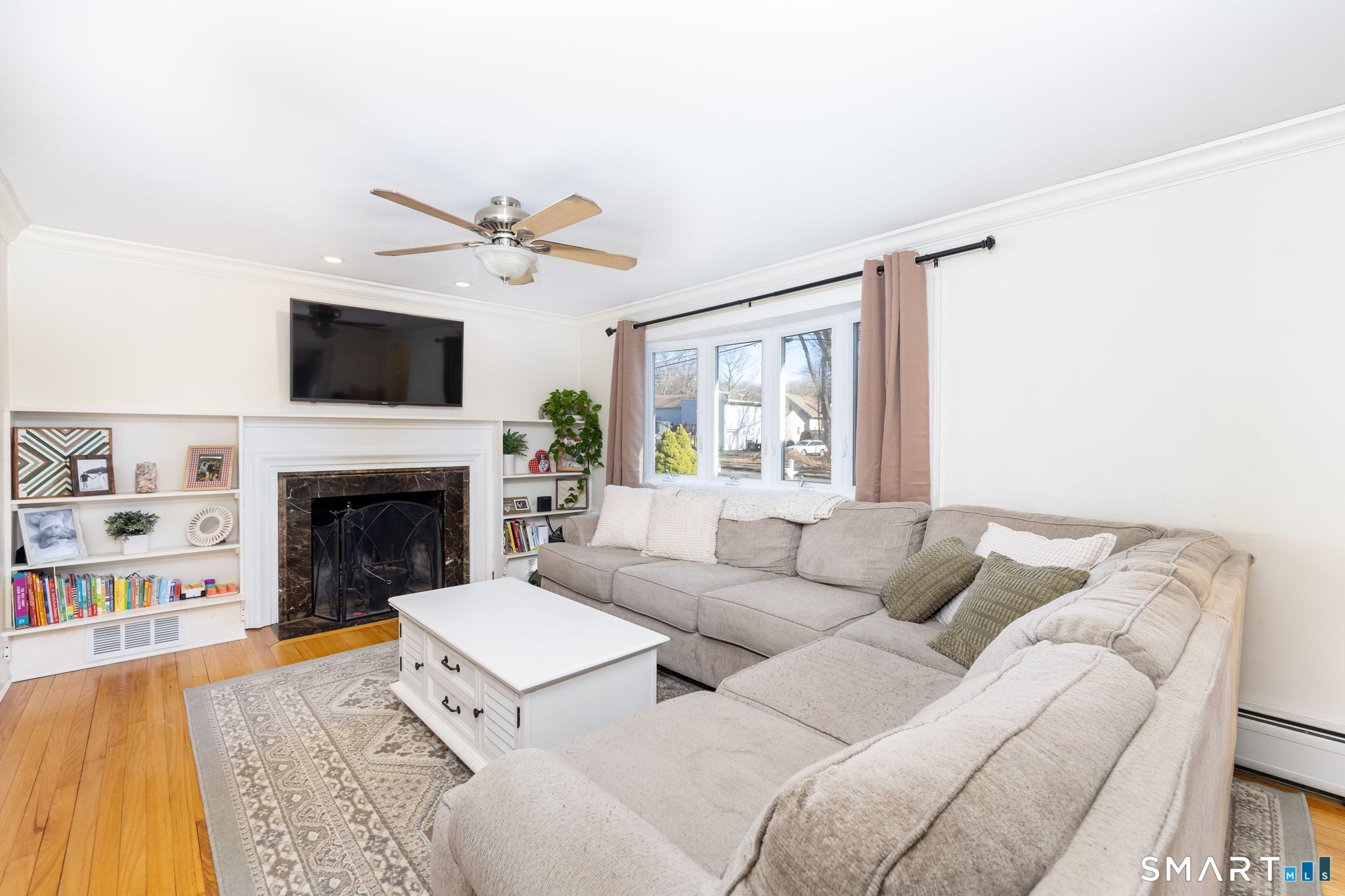 18 Debra Lane Bristol, CT 06010 - Photo 9 of 32 a living room with furniture a flat screen tv and a fireplace