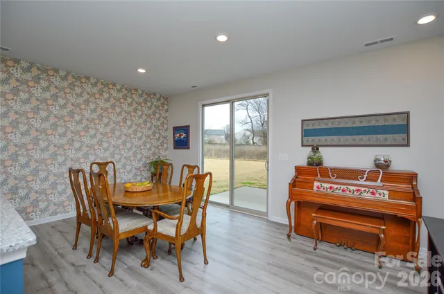 a dining room with furniture and wooden floor