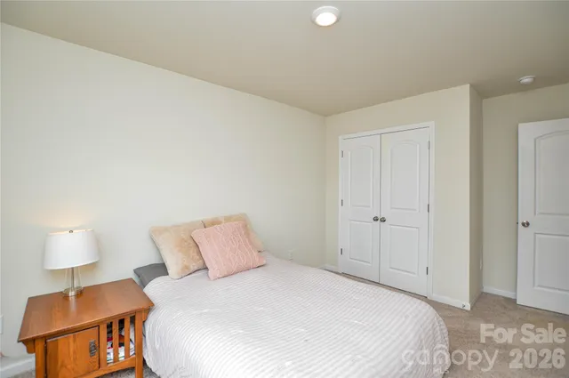 a bedroom with a bed and a lamp