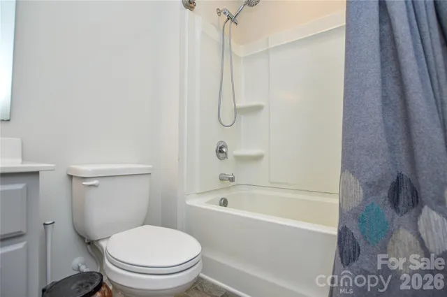 a white bath tub sitting next to a toilet