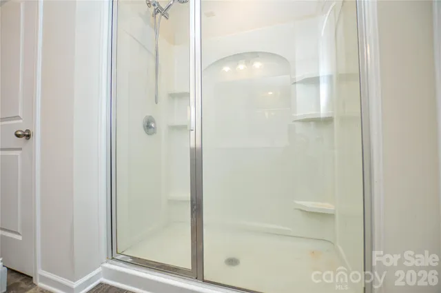a bathroom with a glass shower door