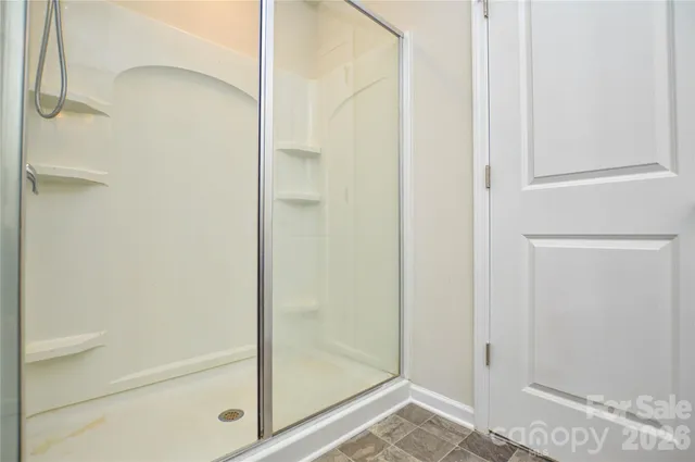 a bathroom with a glass shower door