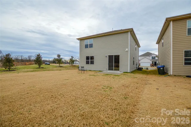 a view of a house with backyard and lake