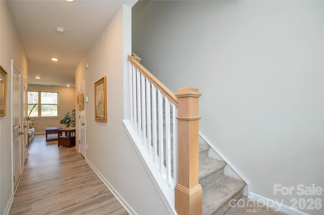 a view of a living room with wooden floor and a chandelier