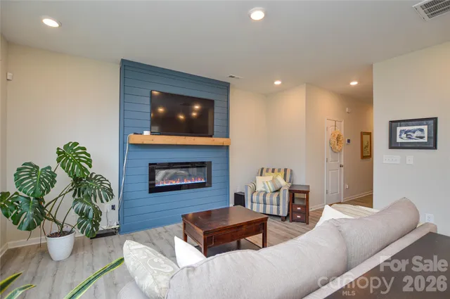a living room with furniture potted plant and a fireplace