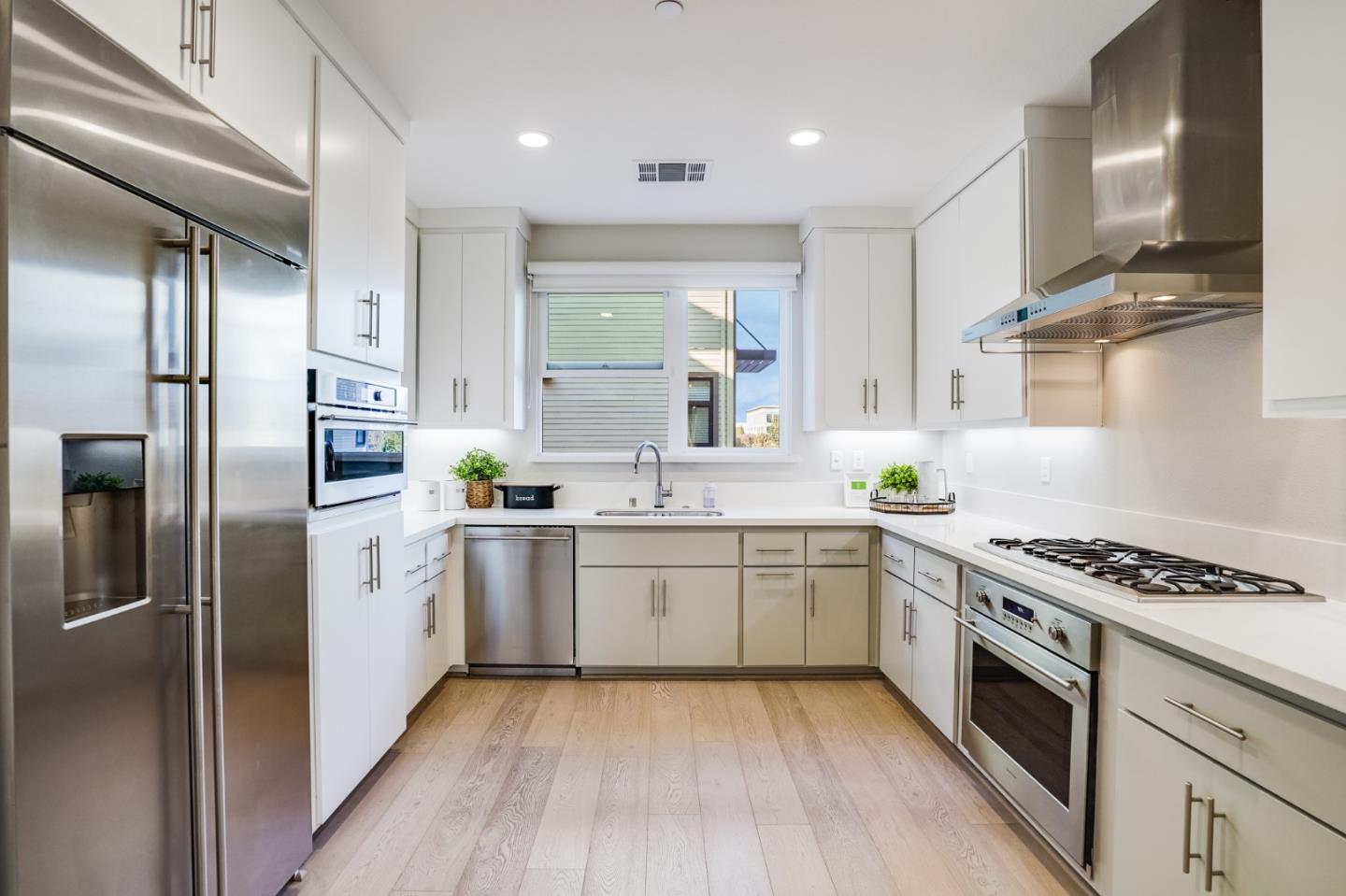 415 Franklin Parkway San Mateo, CA 94403 - Photo 12 of 31 a kitchen with stainless steel appliances granite countertop a stove top oven a sink and dishwasher