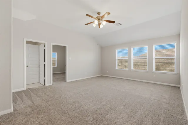a view of a balcony with furniture and floor to ceiling window
