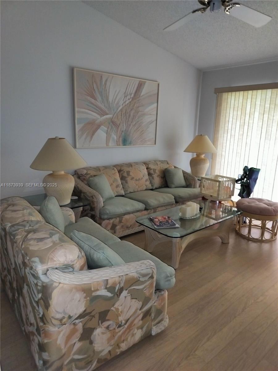 1002 Keystone Drive, Unit F Jupiter, FL 33458 - Photo 3 of 10 a living room with furniture and a large window