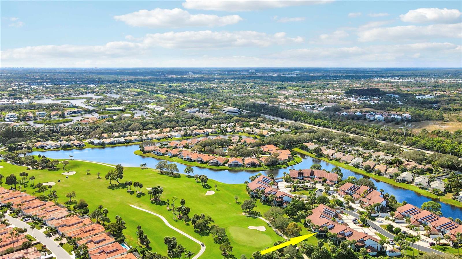 16600 Traders Crossing South, Unit 253 Jupiter, FL 33477 - Photo 21 of 67 an aerial view of residential building and lake