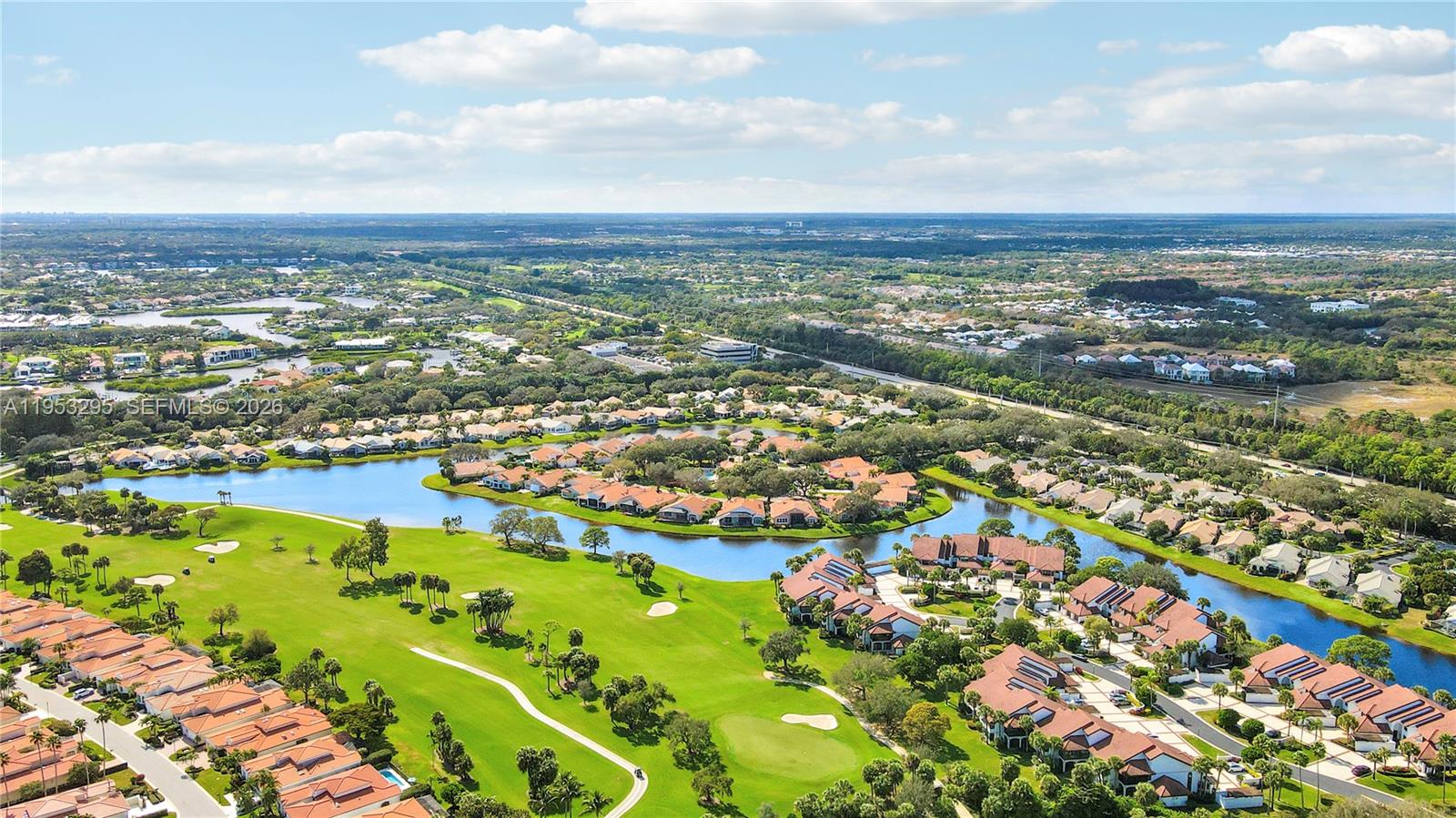 16600 Traders Crossing South, Unit 253 Jupiter, FL 33477 - Photo 22 of 67 an aerial view of residential building and lake
