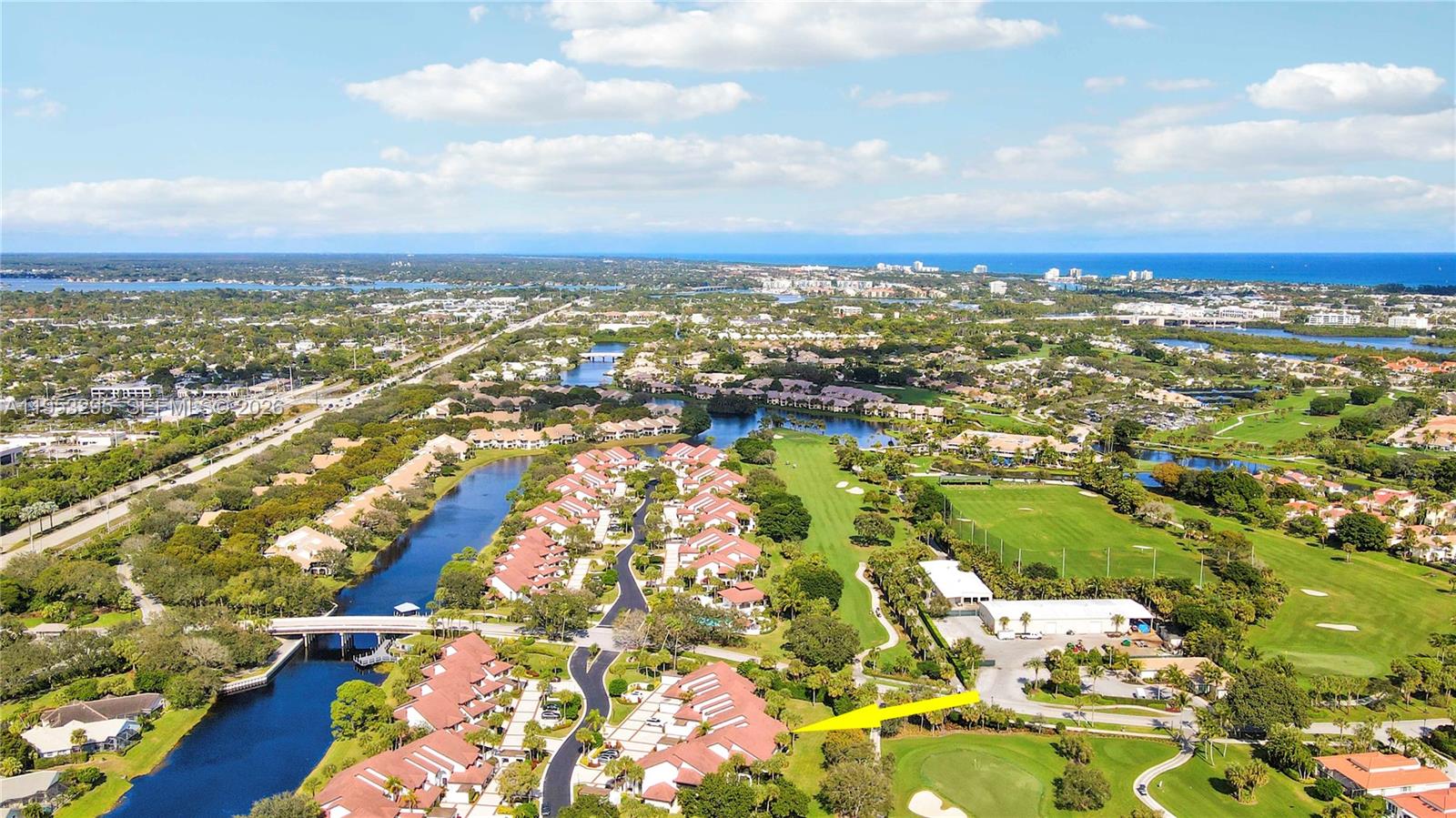 16600 Traders Crossing South, Unit 253 Jupiter, FL 33477 - Photo 23 of 67 an aerial view of residential building with yard