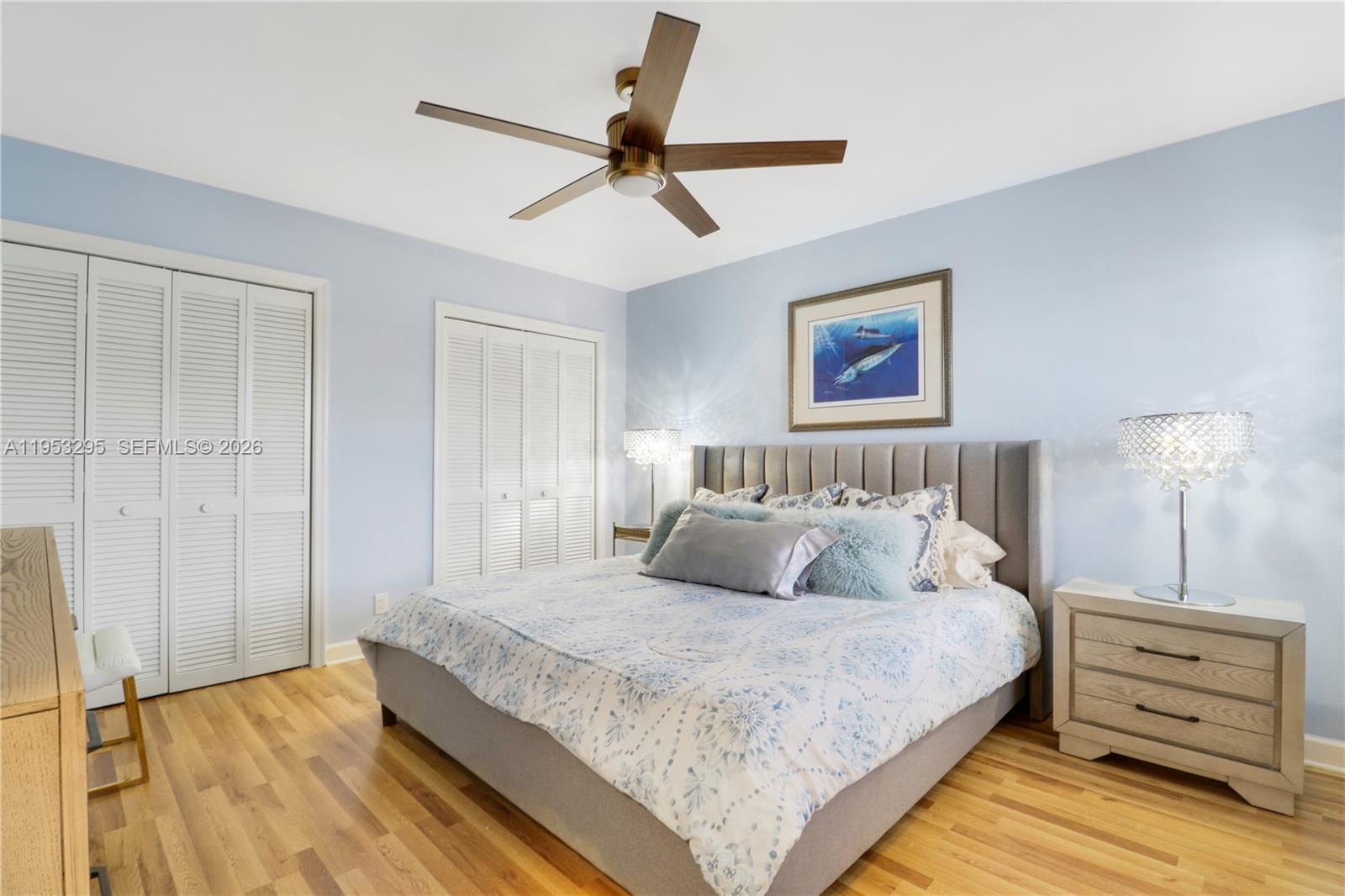 16600 Traders Crossing South, Unit 253 Jupiter, FL 33477 - Photo 35 of 67 a bedroom with a bed and a night stand