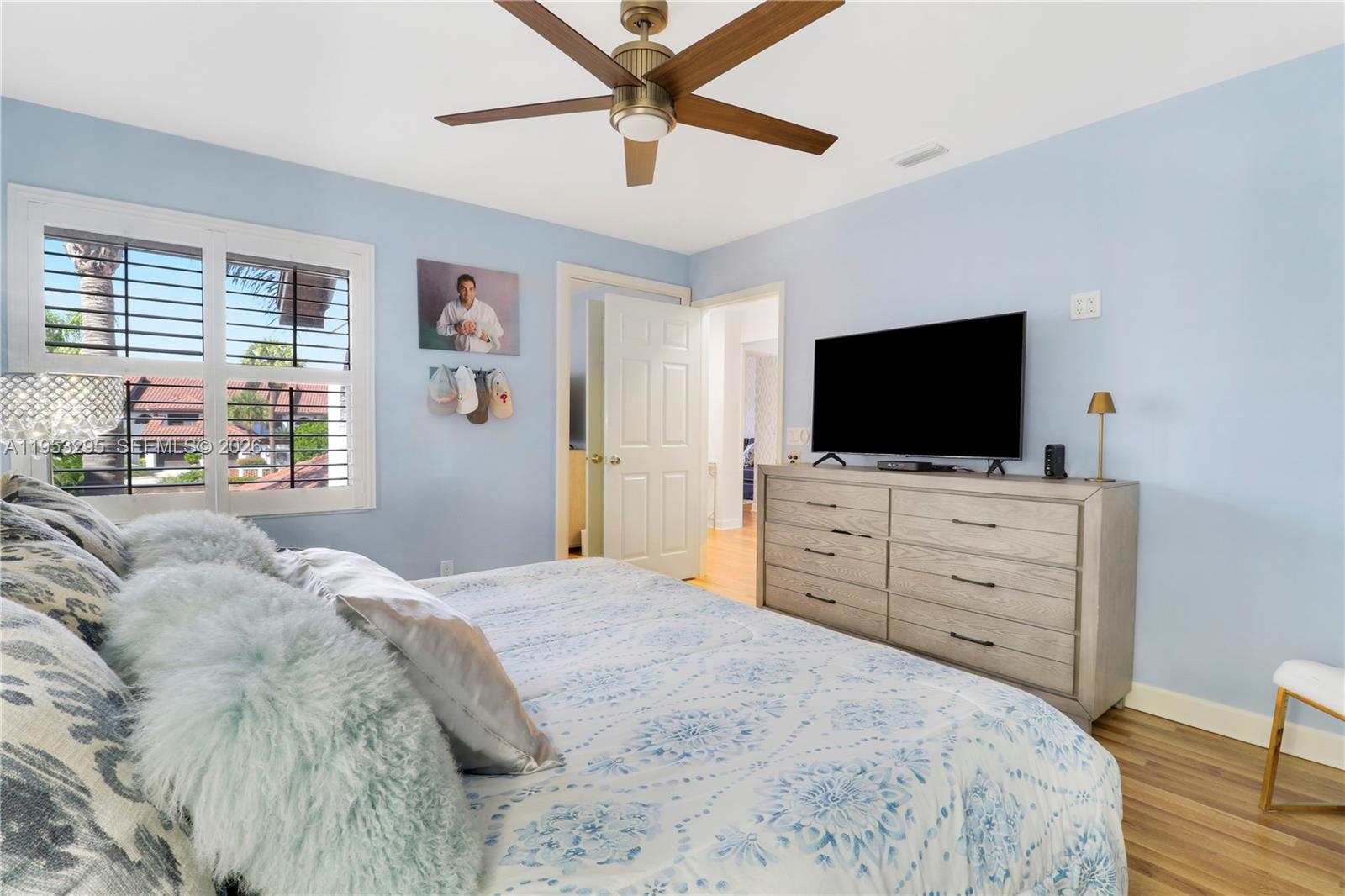 16600 Traders Crossing South, Unit 253 Jupiter, FL 33477 - Photo 36 of 67 a bedroom with a bed and a flat screen tv