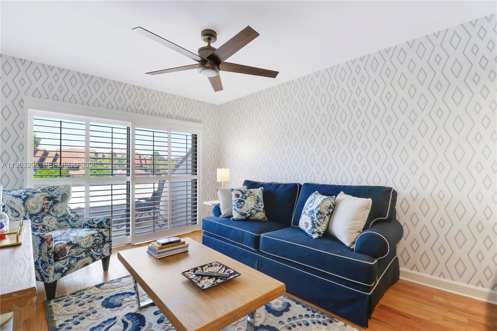 16600 Traders Crossing South, Unit 253 Jupiter, FL 33477 - Photo 37 of 67 a living room with furniture and a large window