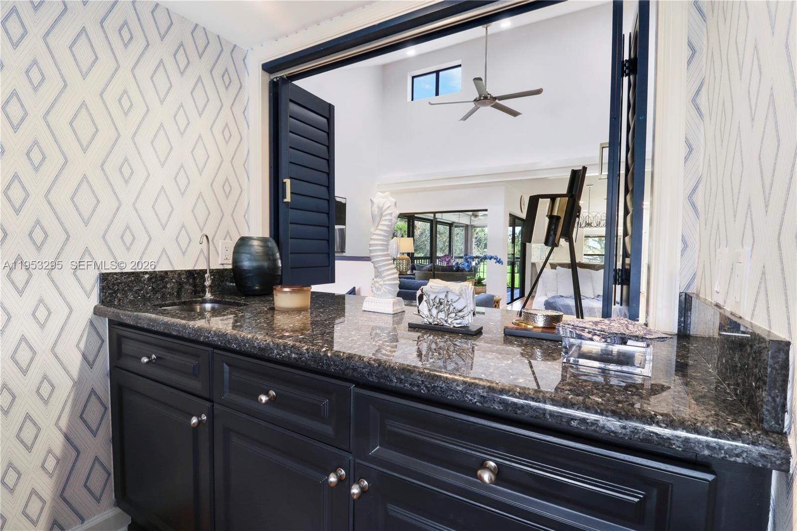 16600 Traders Crossing South, Unit 253 Jupiter, FL 33477 - Photo 39 of 67 a bathroom with a granite countertop sink and a mirror