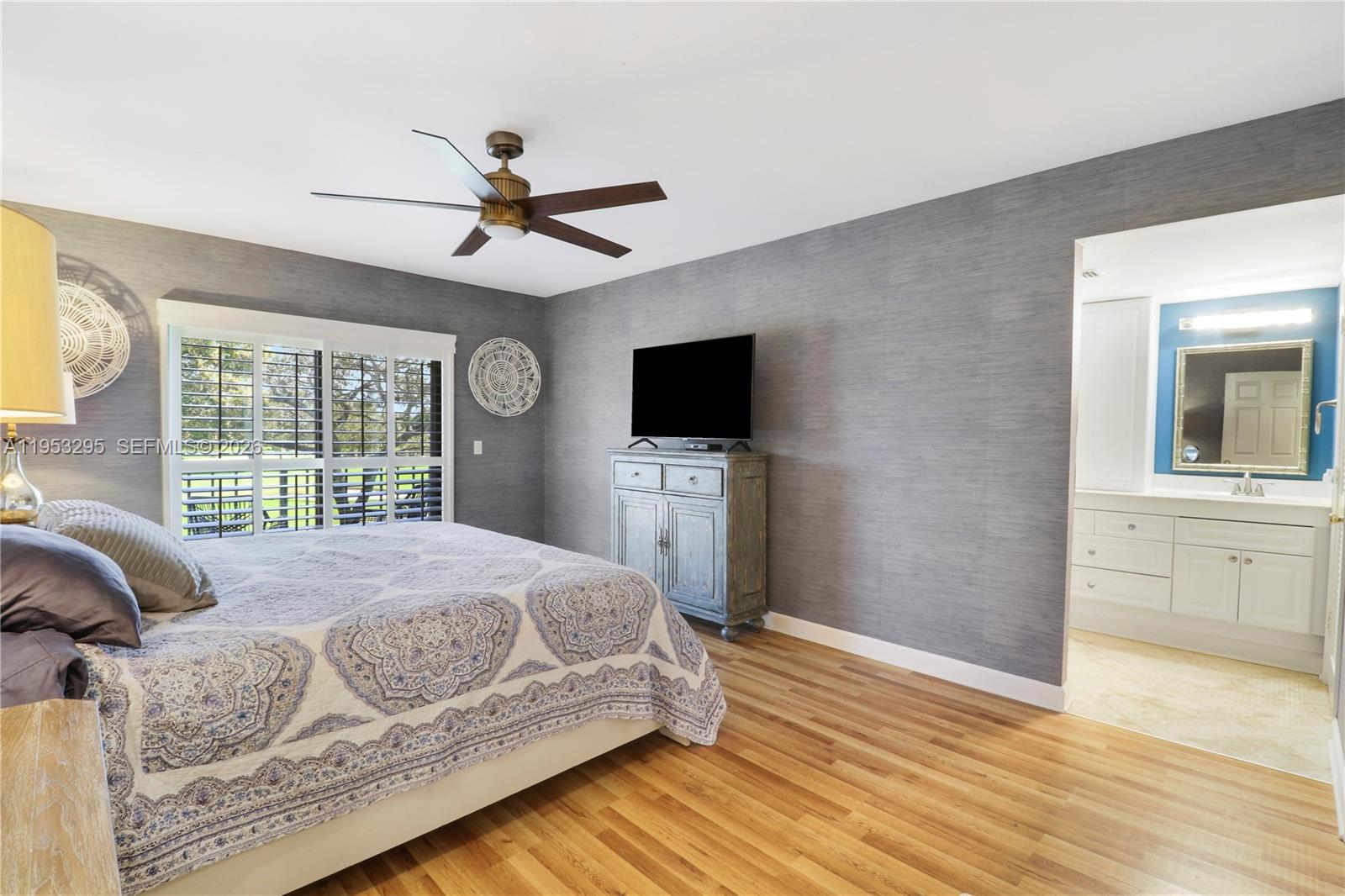 16600 Traders Crossing South, Unit 253 Jupiter, FL 33477 - Photo 40 of 67 a bedroom with a bed a window and a flat screen tv