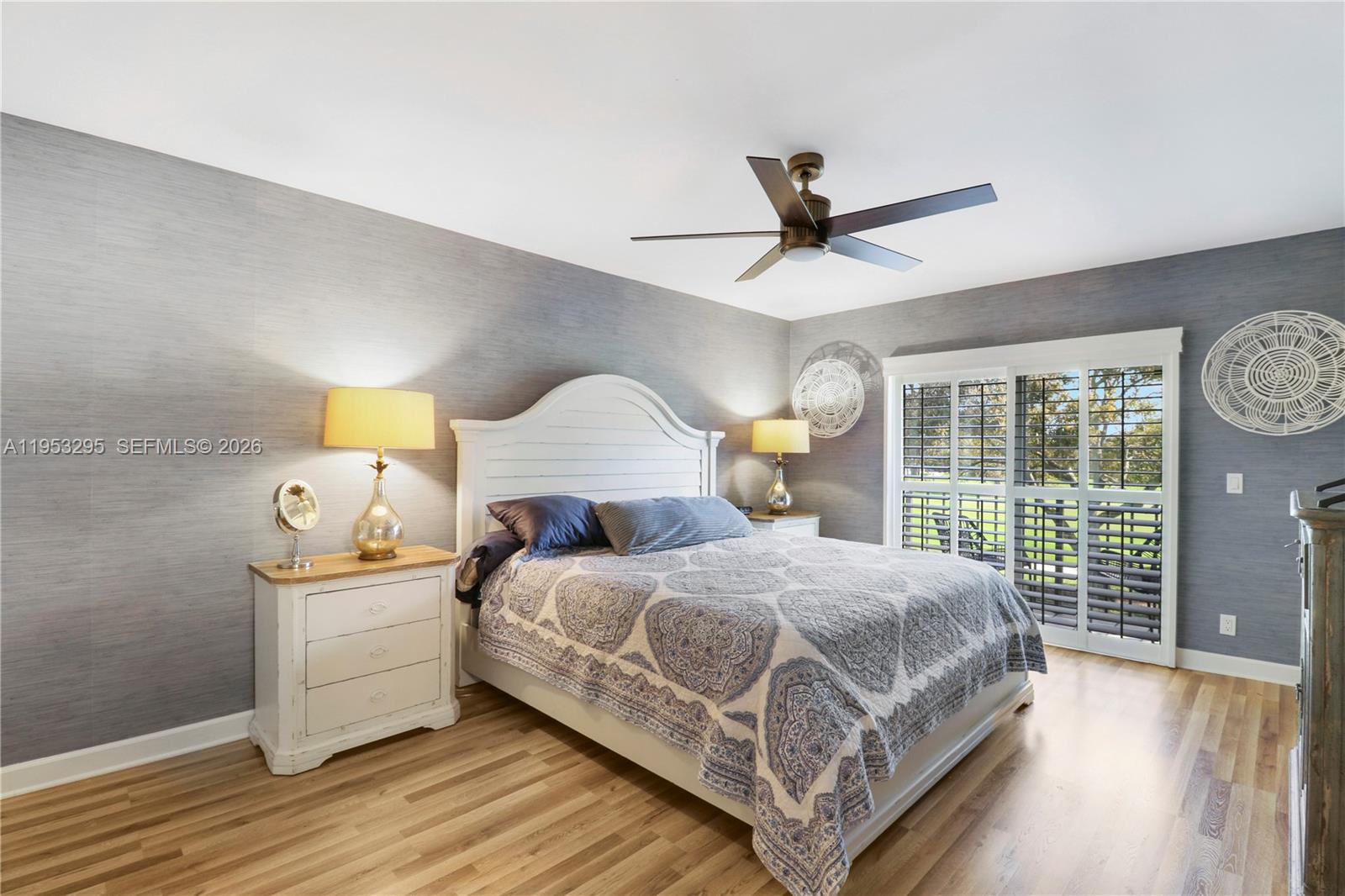 16600 Traders Crossing South, Unit 253 Jupiter, FL 33477 - Photo 41 of 67 a bedroom with a bed and wooden floor