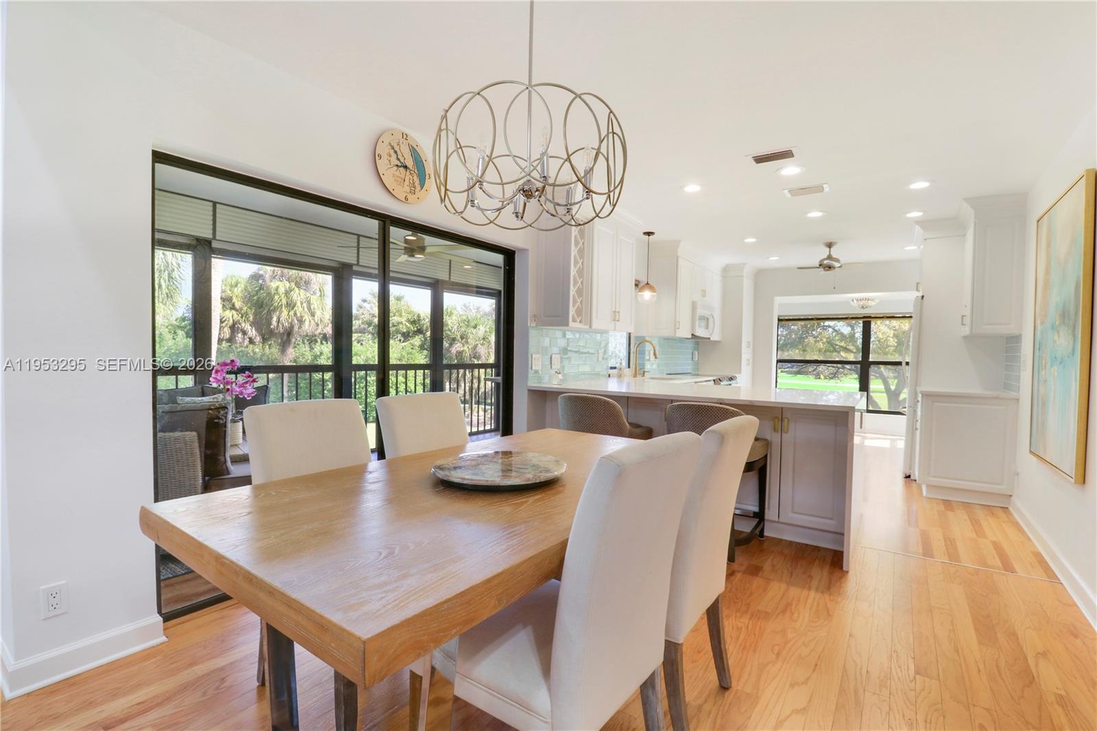 16600 Traders Crossing South, Unit 253 Jupiter, FL 33477 - Photo 50 of 67 a view of a dining room with furniture wooden floor and chandelier