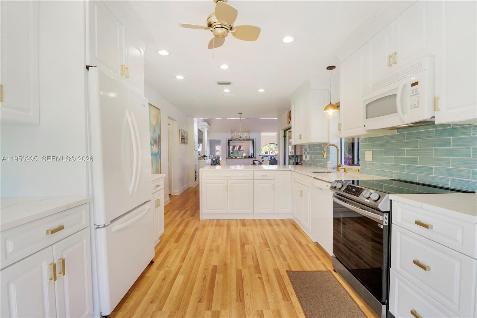 16600 Traders Crossing South, Unit 253 Jupiter, FL 33477 - Photo 56 of 67 a kitchen with stainless steel appliances granite countertop a sink and a stove top oven