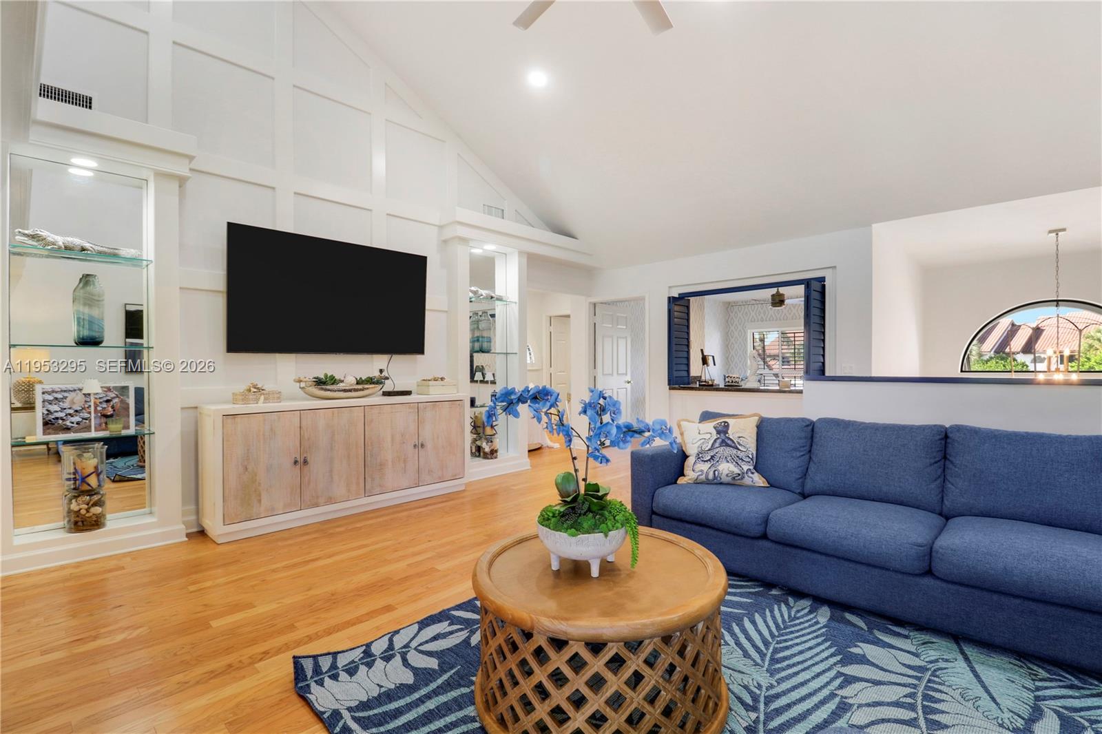 16600 Traders Crossing South, Unit 253 Jupiter, FL 33477 - Photo 58 of 67 a living room with furniture and a flat screen tv