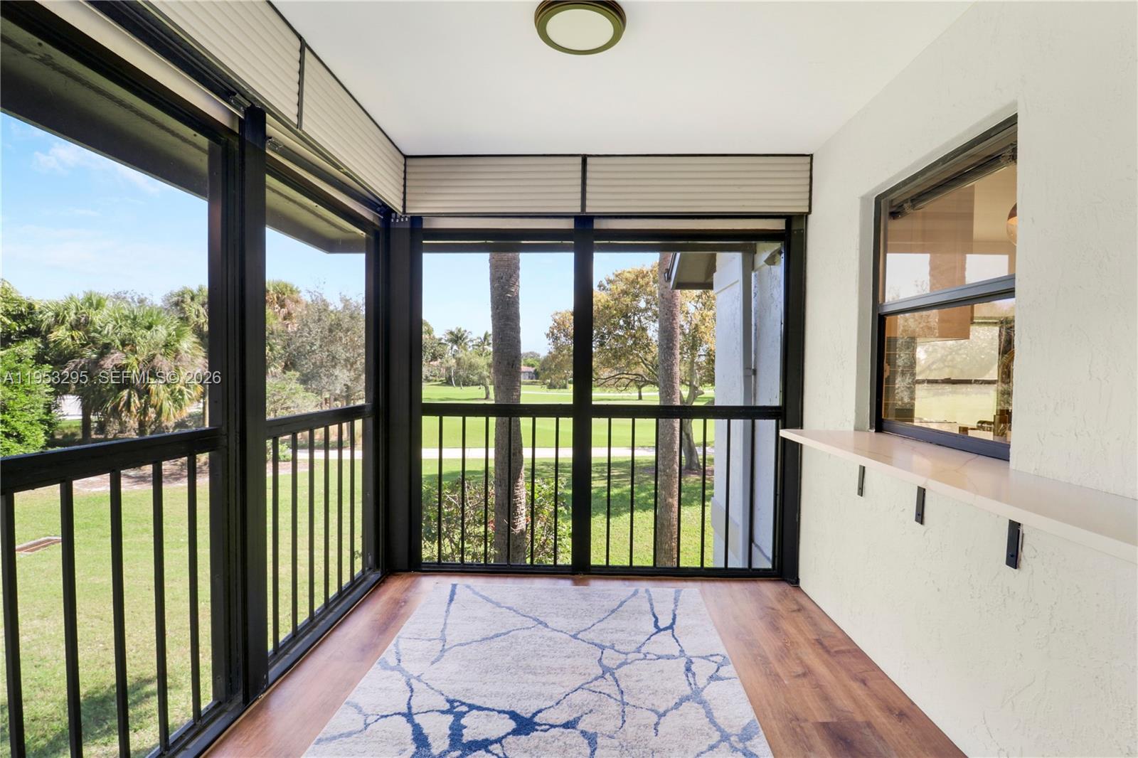16600 Traders Crossing South, Unit 253 Jupiter, FL 33477 - Photo 60 of 67 a view of a hallway with wooden floor and windows