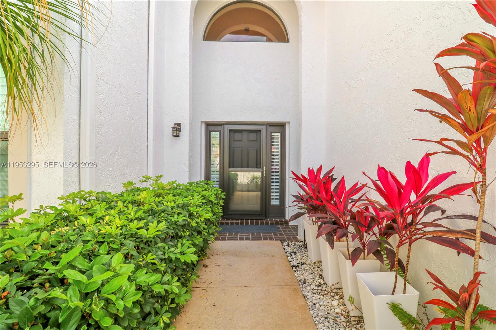16600 Traders Crossing South, Unit 253 Jupiter, FL 33477 - Photo 65 of 67 a view of a house with a flower garden