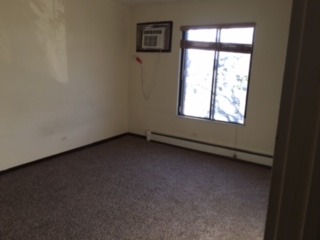 125 North Gregory Street, Unit 9 Aurora, IL 60504 - Photo 2 of 3 an empty room with a window