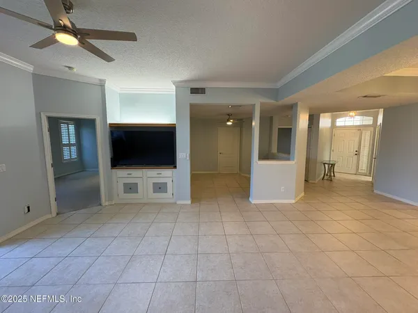 a view of a big room with closet and a chandelier fan