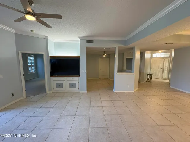 a view of a big room with closet and a chandelier fan
