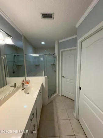 a view of an empty room and a ceiling fan and window