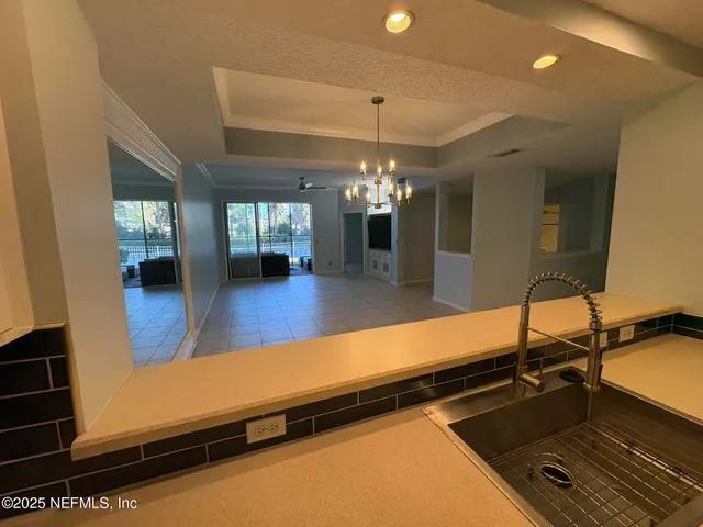 a room with pool table and windows