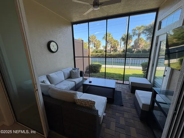 a living room with furniture and a floor to ceiling window