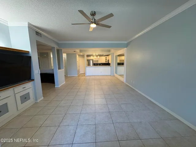 a view of an empty room with a fireplace and a window