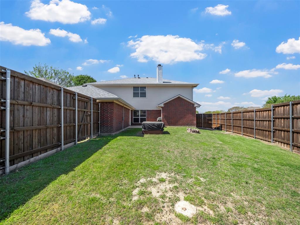 741 Aspen Court Allen, TX 75002 - Photo 4 of 40 Back of property with brick siding, a fenced backyard, and a chimney