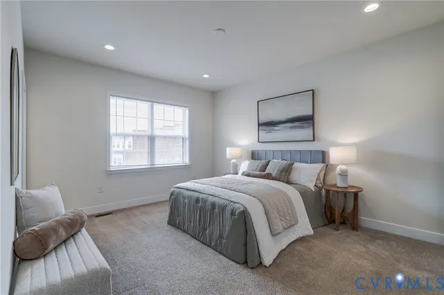 a bedroom with a bed and a large window